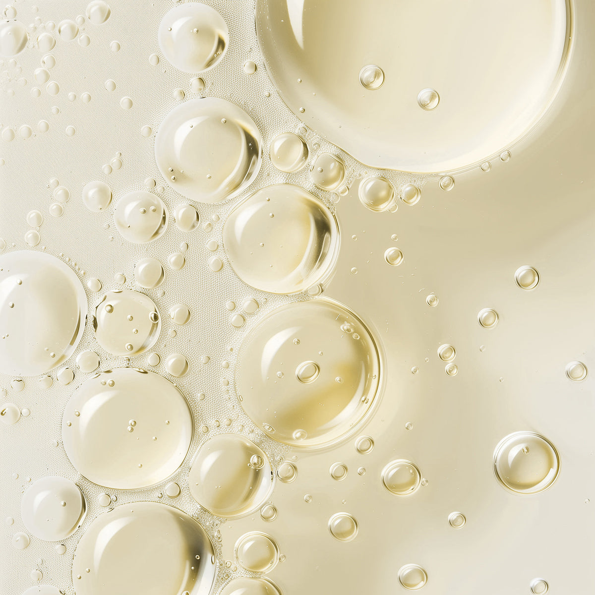 Close-up of oil bubbles on a light beige background