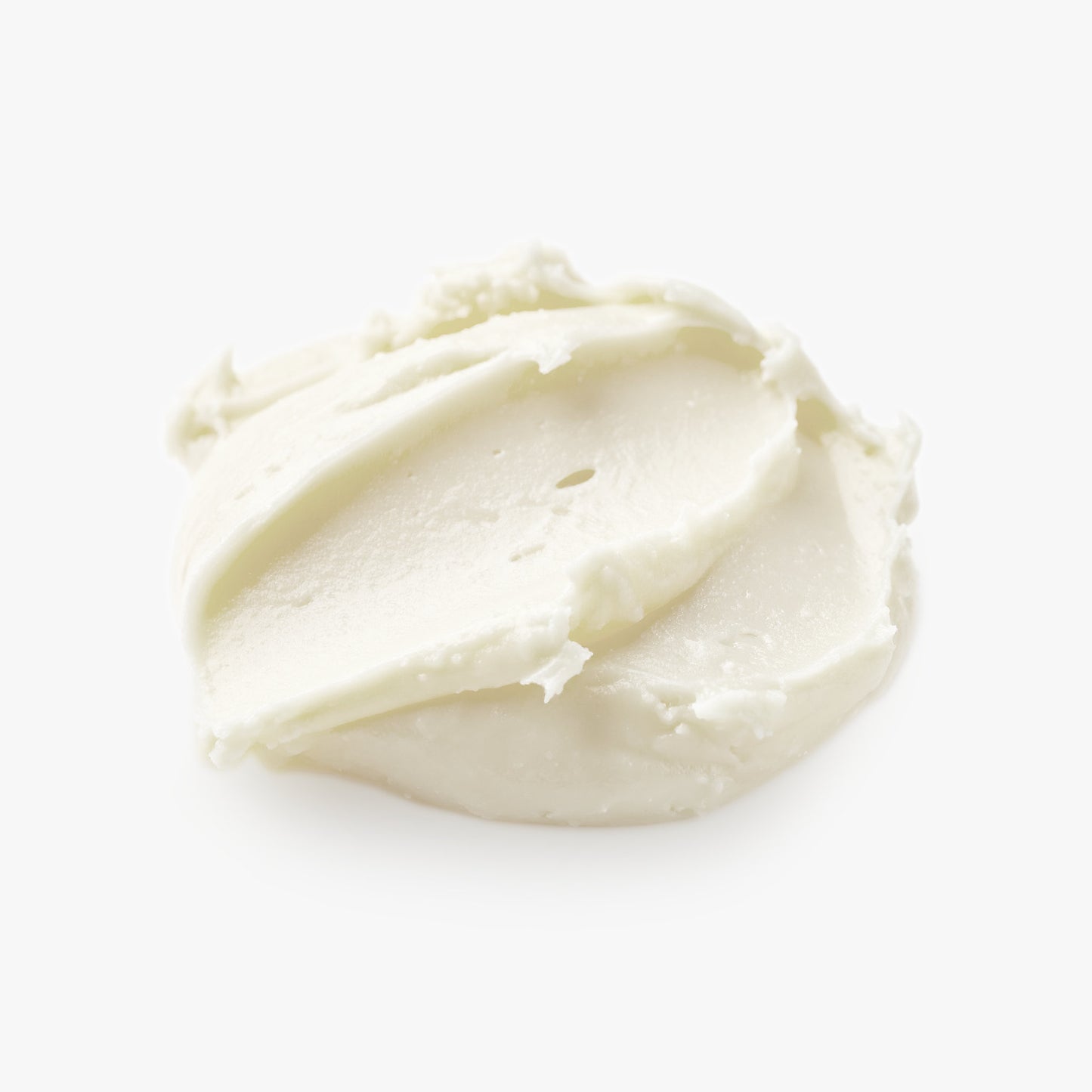 Close-up of a smooth, white cream on a light beige background
