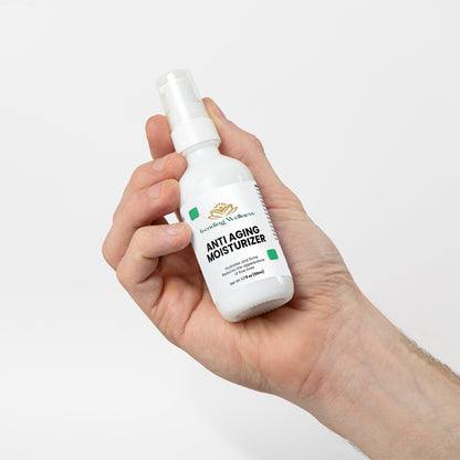 Hand holding a bottle of 'Vita-Young' moisturizer against a white background