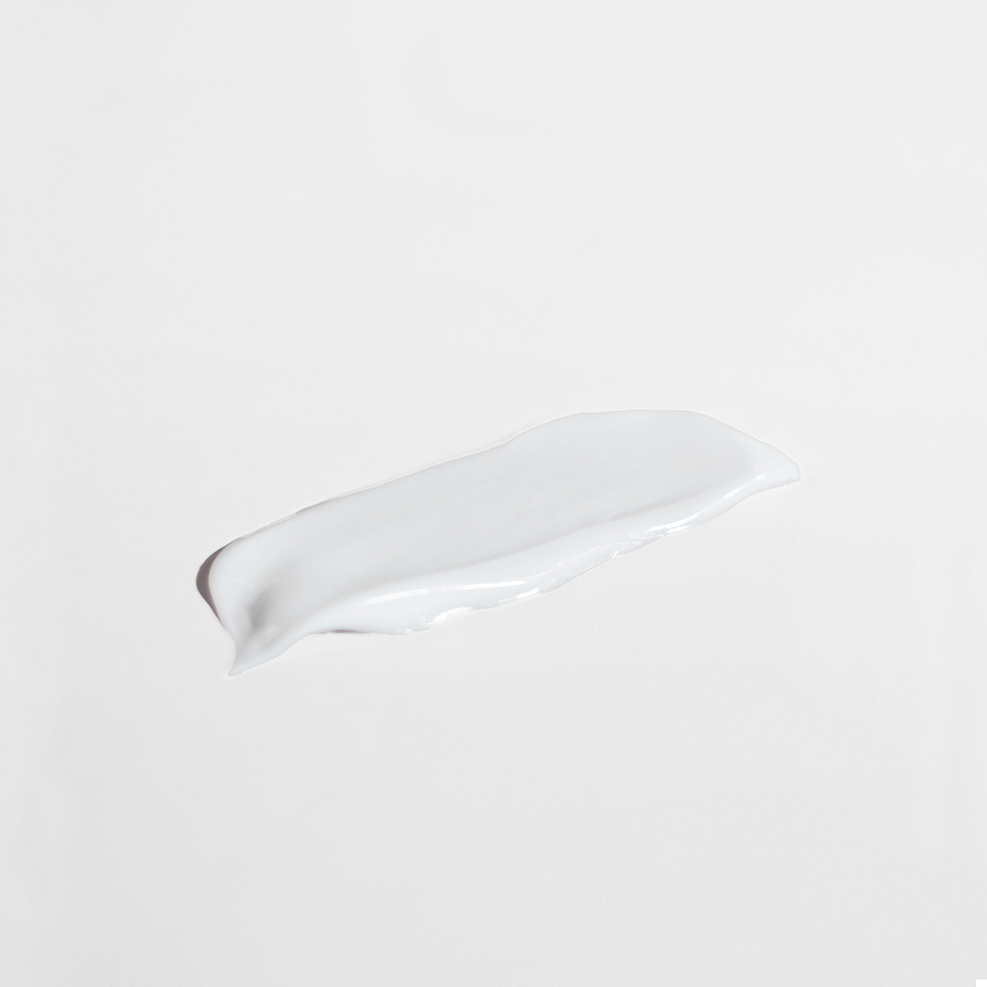 White ceramic spoon rest on a beige background