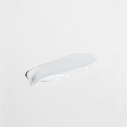 White ceramic spoon rest on a beige background