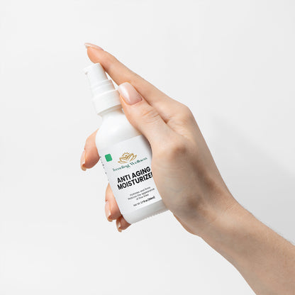 Hand holding a bottle of 'Trending Nature' anti-aging moisturizer against a white background