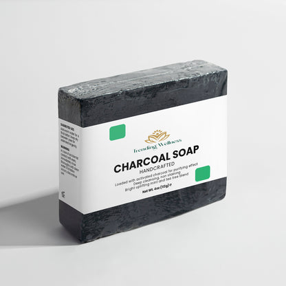 Bar of charcoal soap with a white label on a light gray background