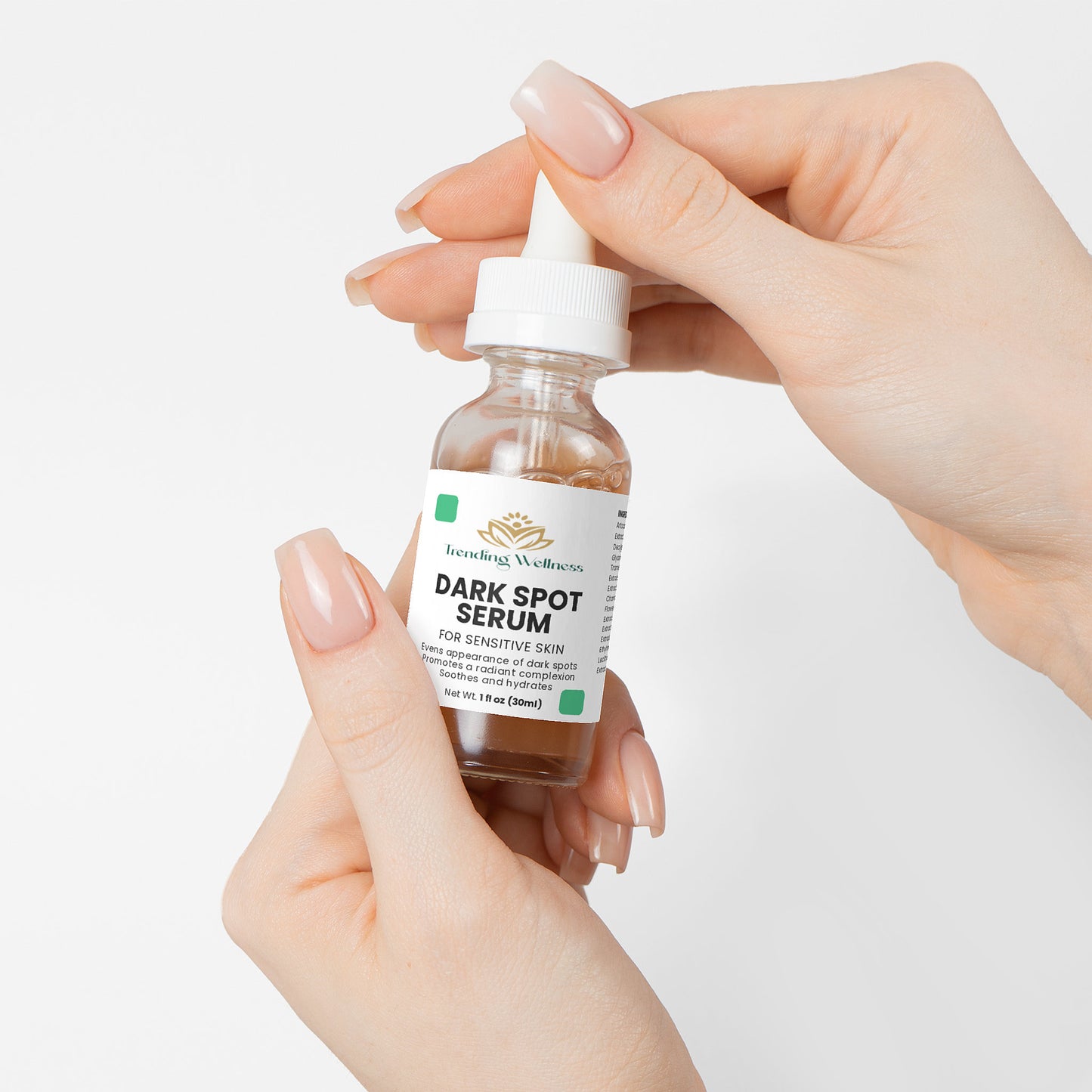 Hand holding a bottle of Soluna Dark Spot Serum against a white background