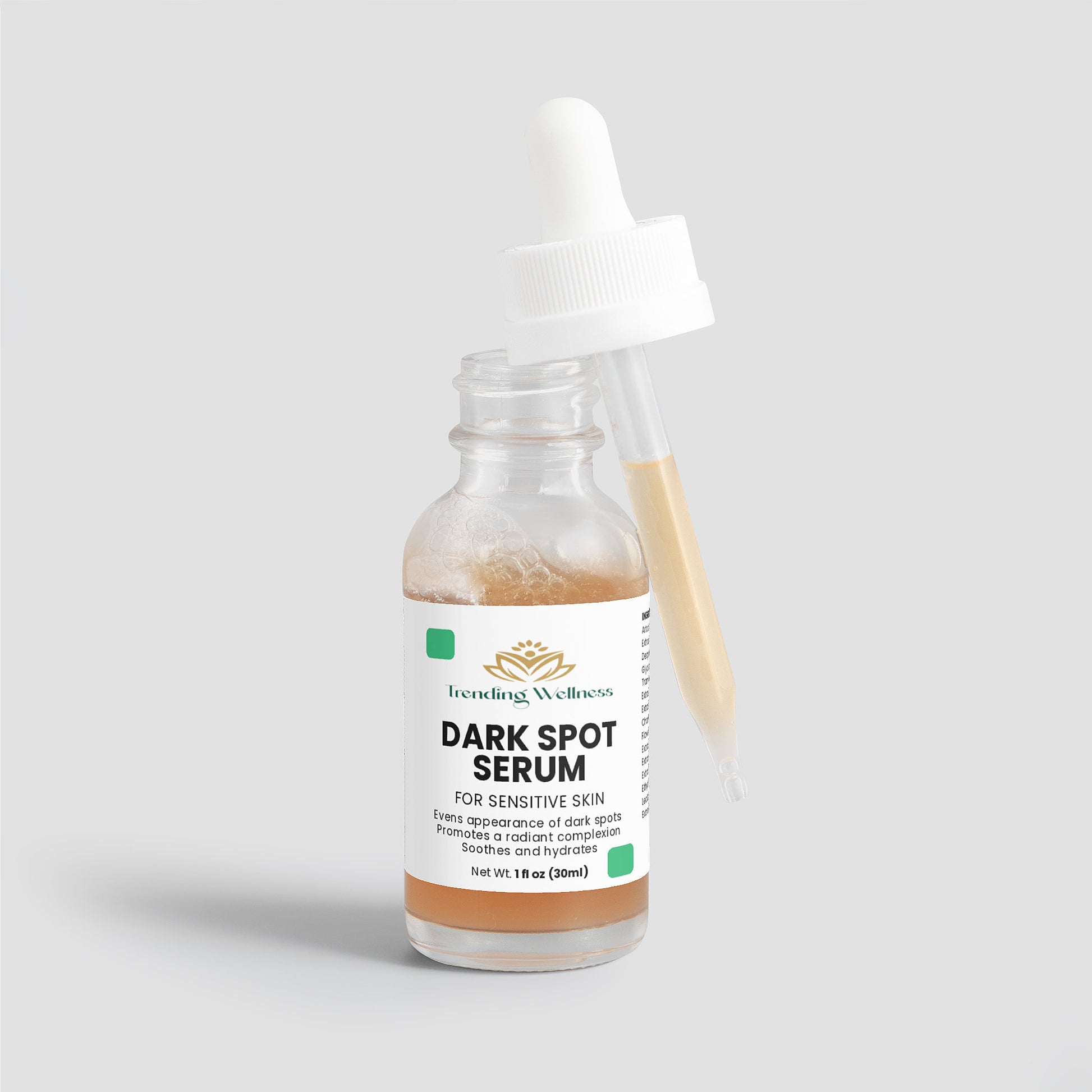 Dark spot serum bottle with dropper on a light gray background