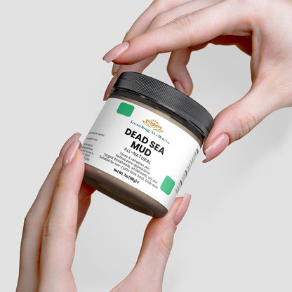 Person holding a jar of Dead Sea Mud with a plain background