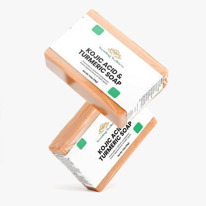 Two bars of Kojic Acid & Turmeric Soap on a white background