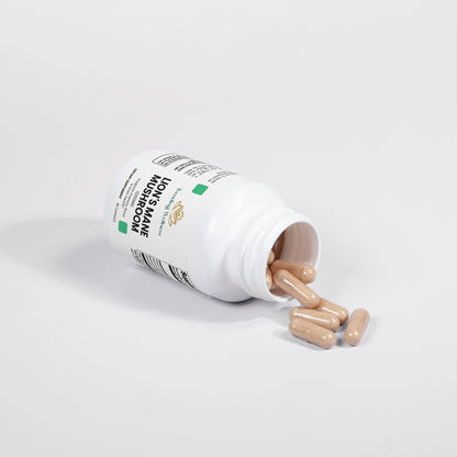 Open bottle of supplements with pills spilling out on a white background