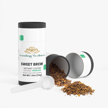 Trending Wellness Sweet Brew instant coffee packaging with coffee grounds and a scoop on a white background