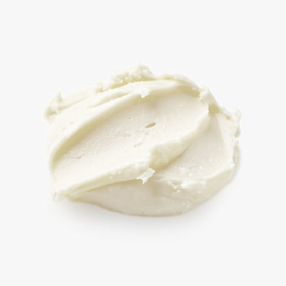 Close-up of a smooth, white cream on a light beige background