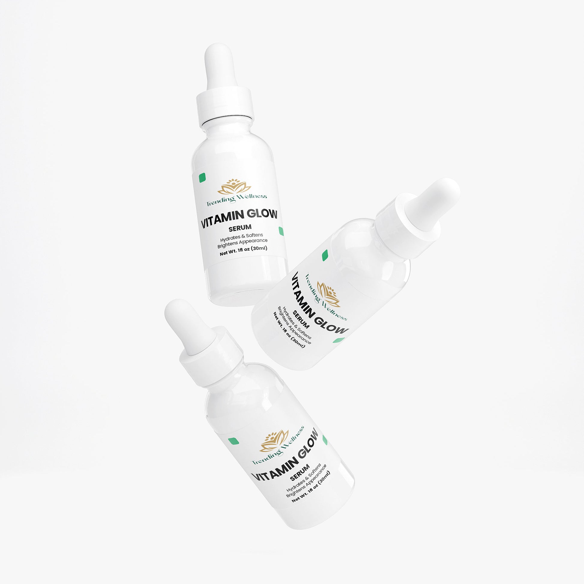 Three bottles of Vitamin Glow serum on a white background